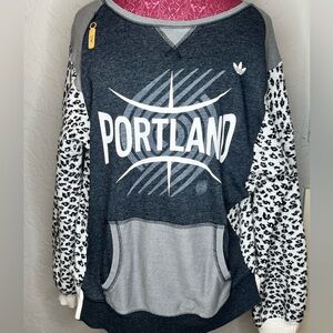 Upcycled Portland Trailblazer print with soft leopard print sweater sleeve.